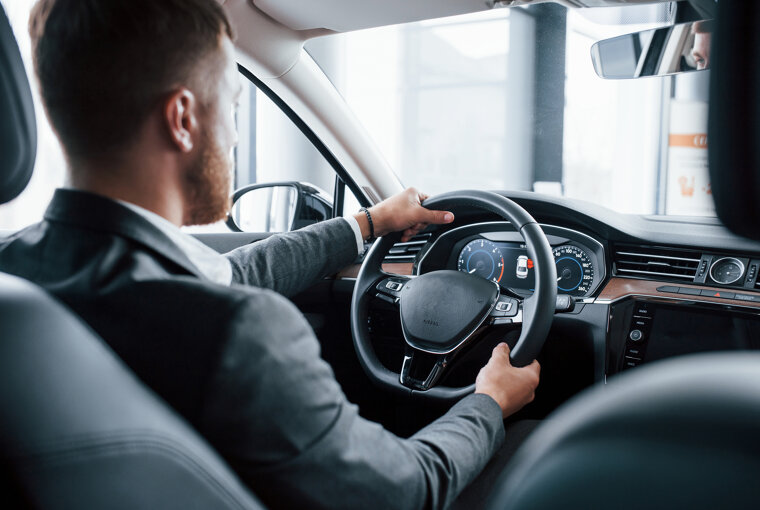 modern-businessman-trying-his-new-car-automobile-salon