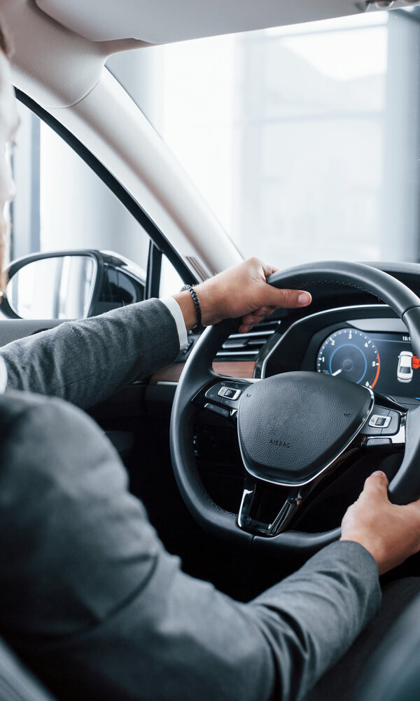 modern-businessman-trying-his-new-car-automobile-salon