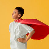 portrait-of-young-boy-with-superhero-cape